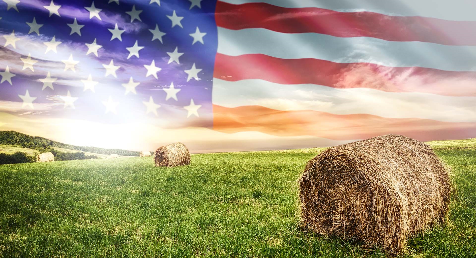 flag in sky with hay bale 